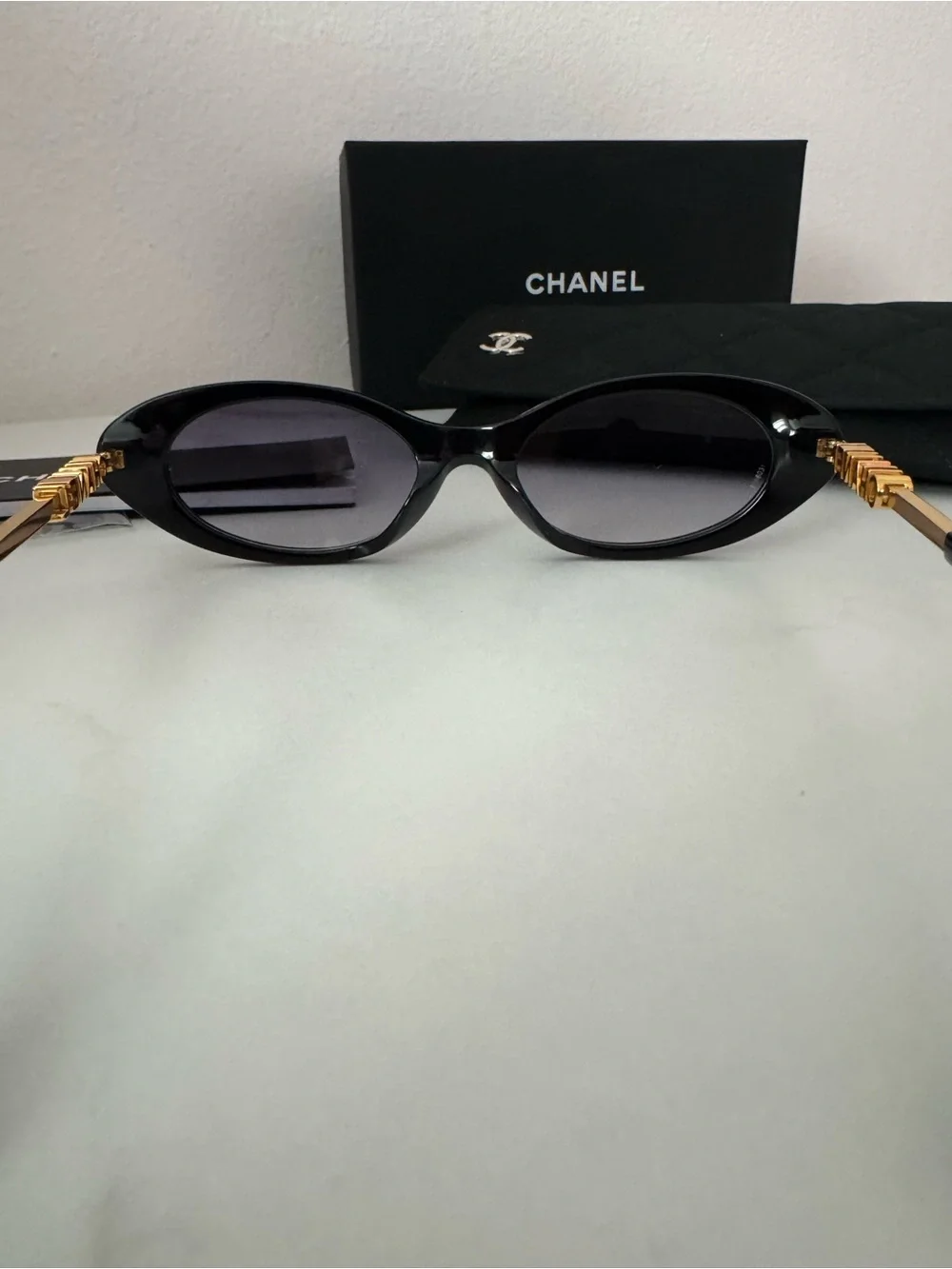 CHANEL Black Oval Sunglasses with Gray Gradient Lenses